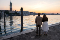 Couple watching the sunrise over the canal