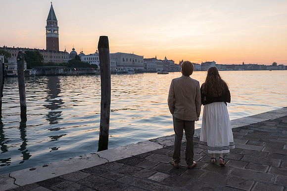 Couple watching the sunrise over the canal