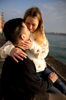 Couple hugging near a waterfront in Venice.