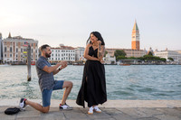Proposal at sunset with ring in hand, Grand Canal reflections behind.