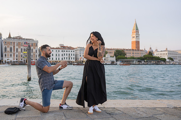 Proposal at sunset with ring in hand, Grand Canal reflections behind.