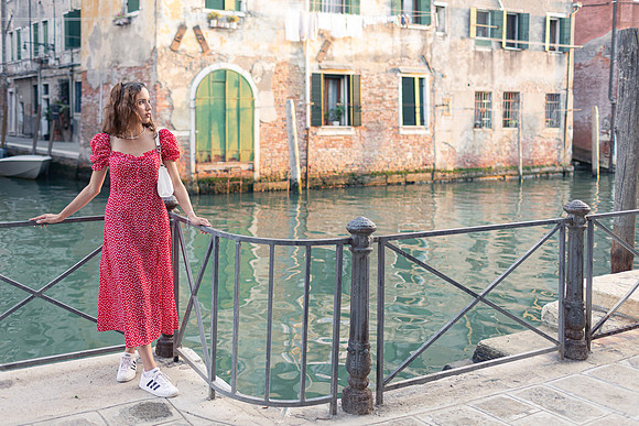 Model strolling by the canal in Venice.