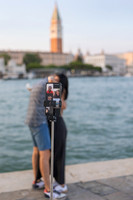 Couple facing each other as proposal begins at Punta della Dogana.