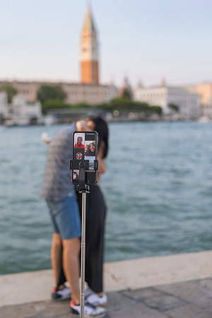 Couple facing each other as proposal begins at Punta della Dogana.