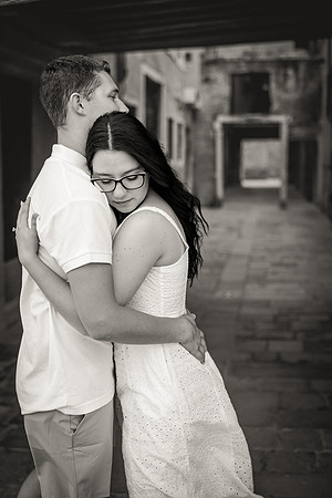 Engaged couple embracing in a quiet Venetian alley
