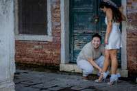 Couple having fun in a rustic alley in Venice.
