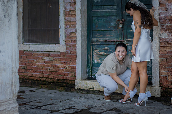 Couple having fun in a rustic alley in Venice.