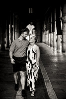 Black and white stroll under Venetian arches after proposal