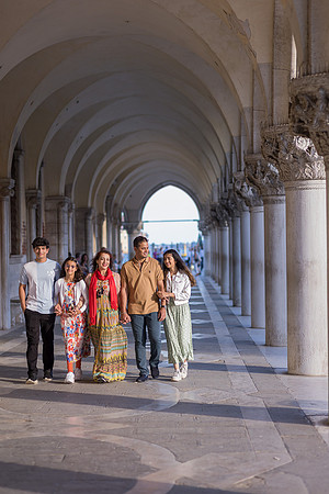 Family walking through Venice archways