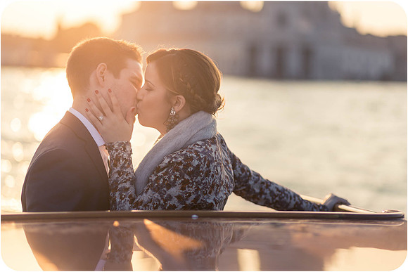 Man placing the engagement ring on his partner’s finger in Venice.