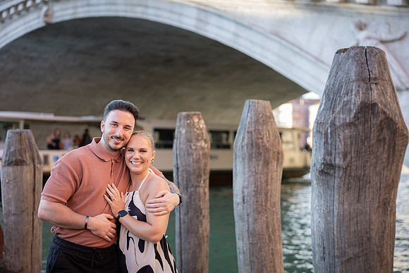 Couple hugging by Rialto Bridge, Venice engagement