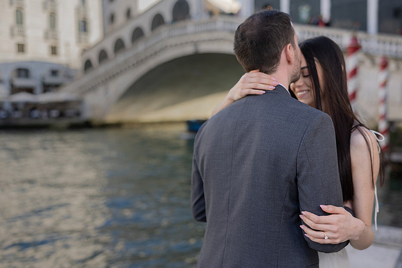 Couple looking at the Grand Canal in Venice after their proposal.