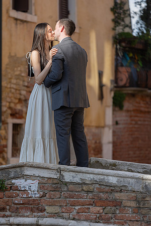 Couple hugging after proposal on a Venetian bridge.
