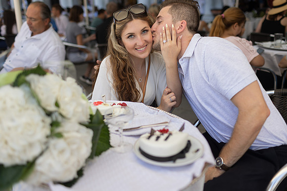 Couple toasting after proposal at Café Florian