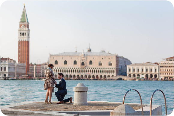 Couple standing close by the waterfront, lost in their love.