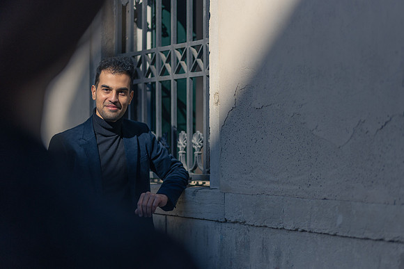 Man standing in Venice, looking confidently before his proposal.