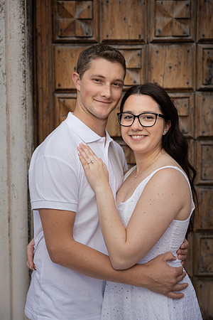 Couple posing by a large door in Venice