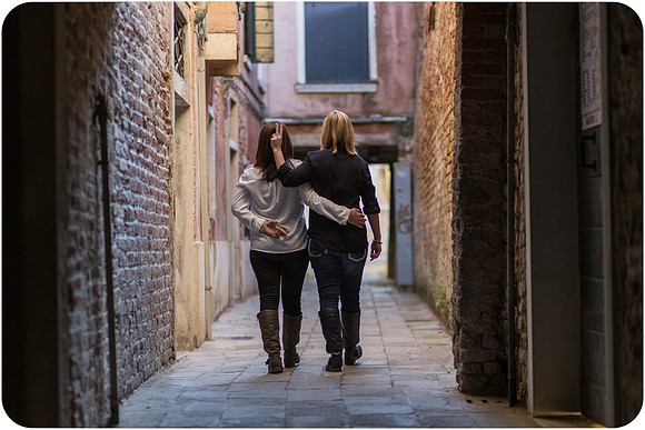 Couple sharing a kiss during their same-sex honeymoon in Venice.