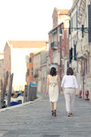 Couple walking hand in hand through Venice
