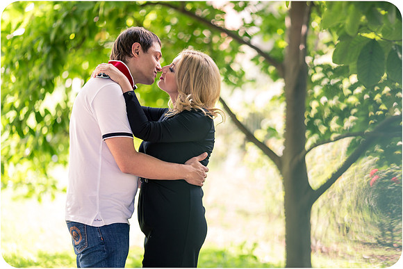 Couple embracing in a Milan park.