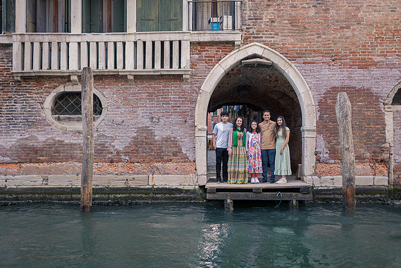Family gondola ride near Rialto Bridge in Venice