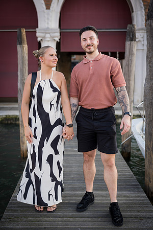 Couple strolling along Venetian dock